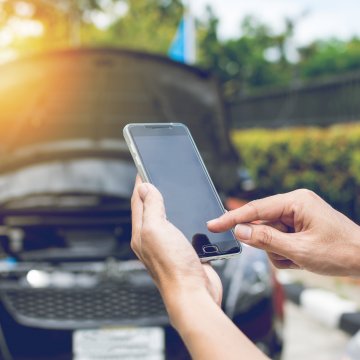 toco warranty corporation extended car warranty service bbb rating man on smartphone making call car broke down open hood